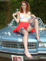 Sid posing in stockings on a chevy